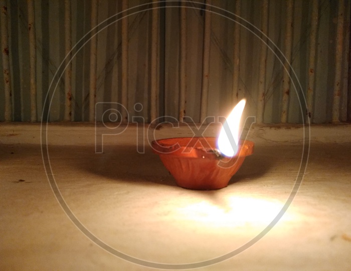 Diwali Diya Lighted  And Placed On Floor Closeup