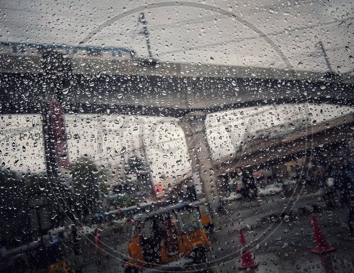 Rain Drops Over Glass With Hyderabad metro in Bokeh Background