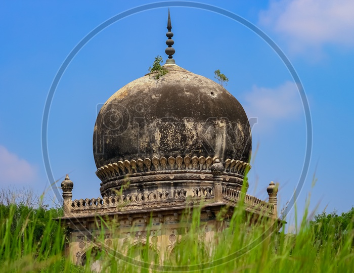 A View Of  Qutub Shahi Tombs With Blue Sky As Background