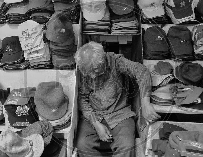 A vendor taking nap  at his stall after lunch