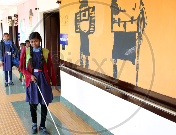 Blind Girl In a School With Hand Stick And Bag Walking In an Corridor
