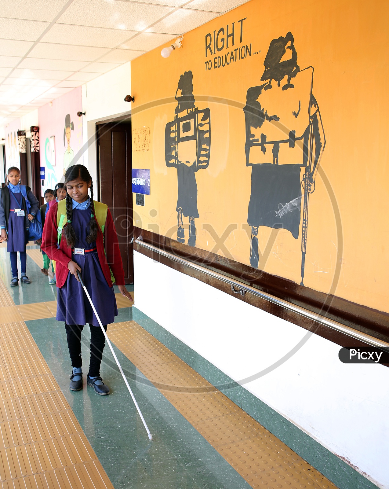 Blind Girl In a School With Hand Stick And Bag Walking In an Corridor