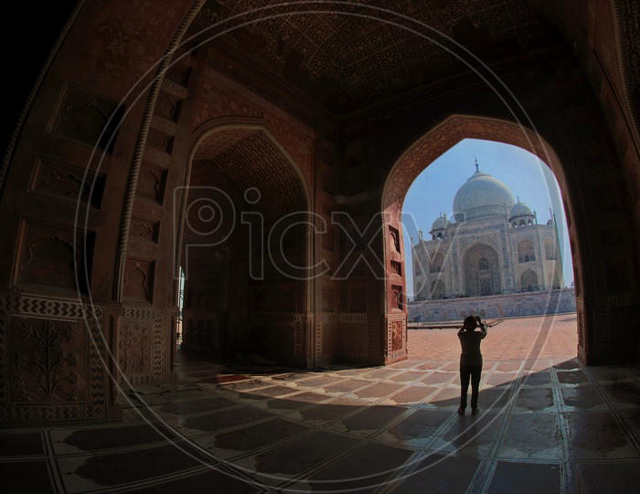 A tourist Taking Picture Of Taj Mahal