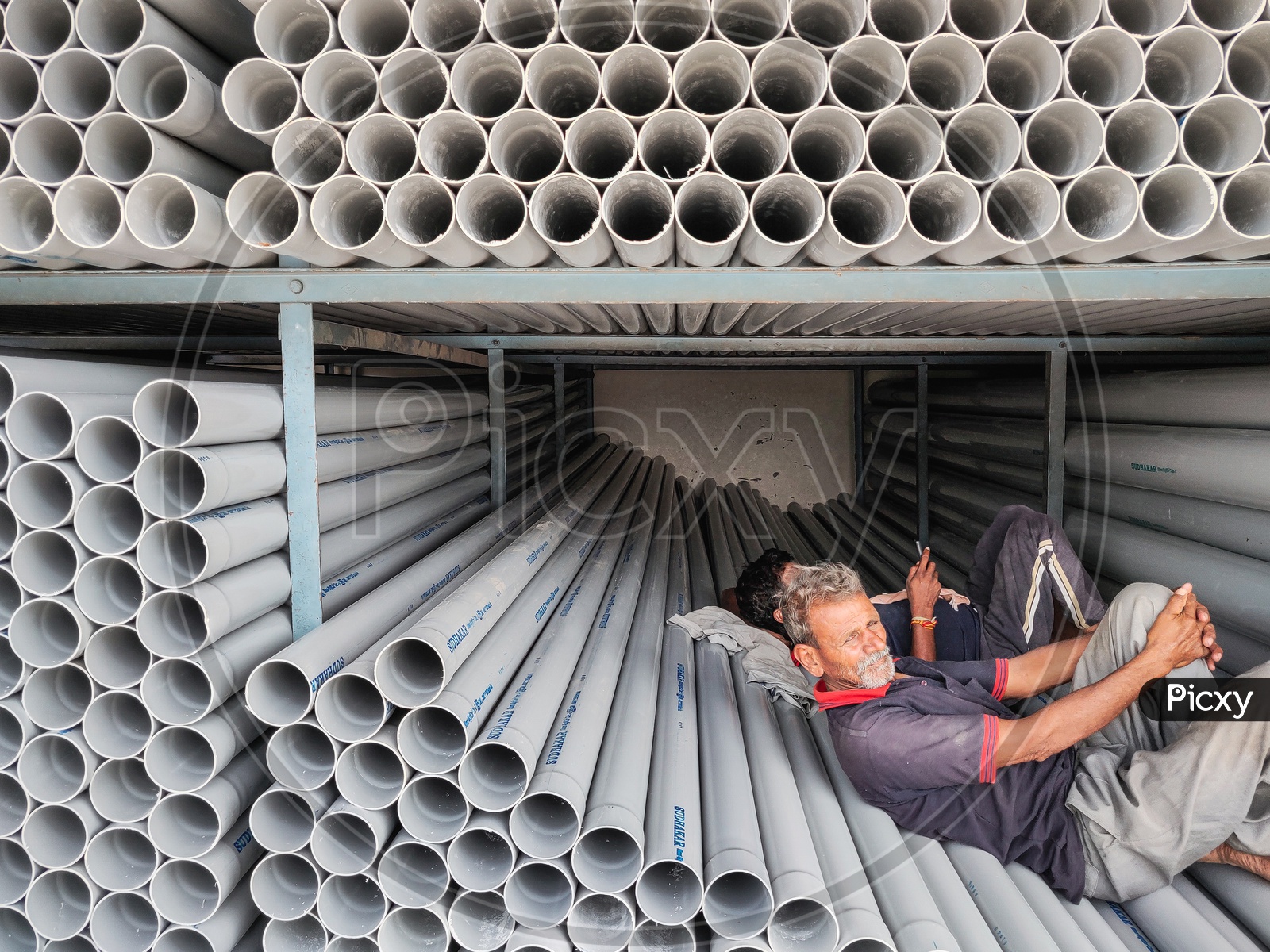 A pic of a worker working in pipe store