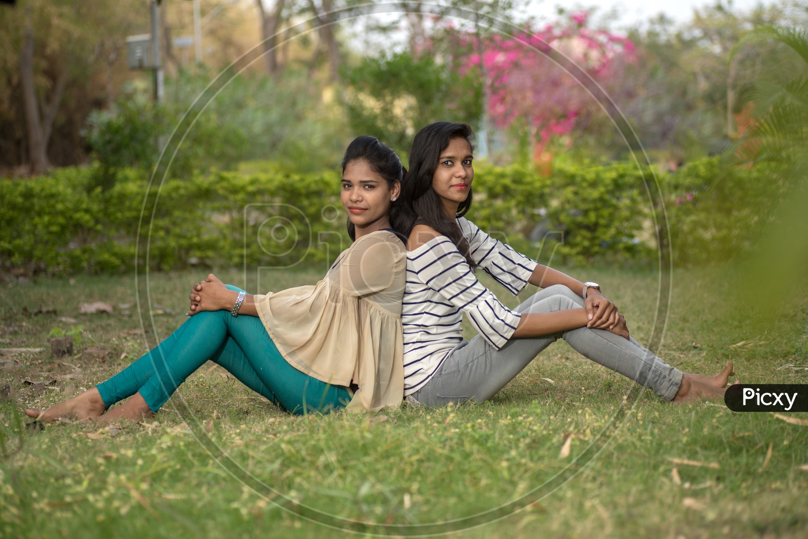 Young Indian Girls Students Friends Posing Outdoor  With Nature Background