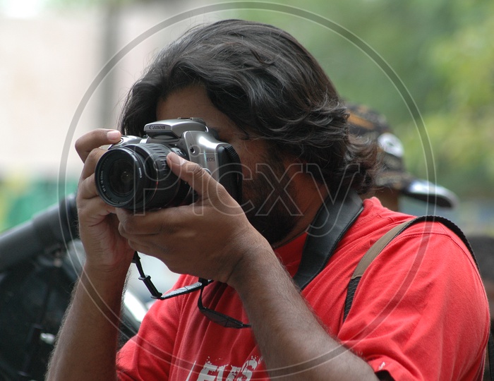 Photographer Taking Pictures With DSLR