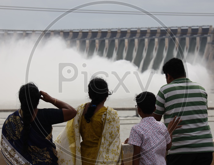 Visitors A Happy Family Watching The Nagarjuna Sagar Dam Water Gushing  From Dam Gates