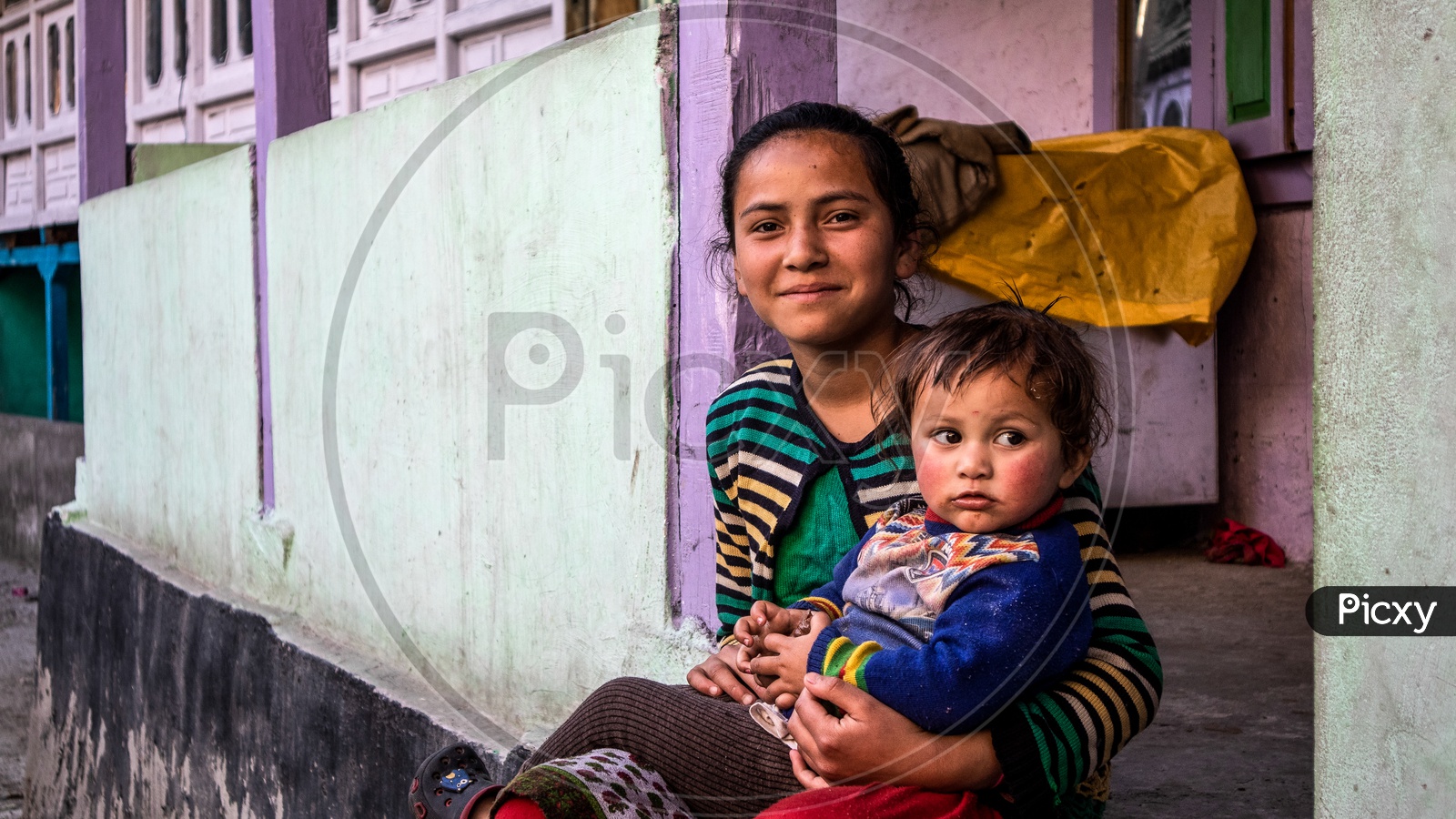 A Girl Child With Her Sibling On The Valley Village Of Leh