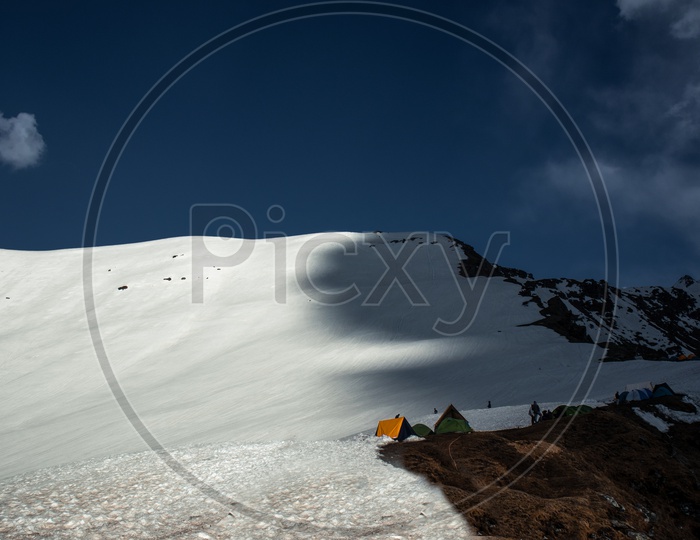 Camp Tents On Snow By trekkers And Adventurers On the Mountains