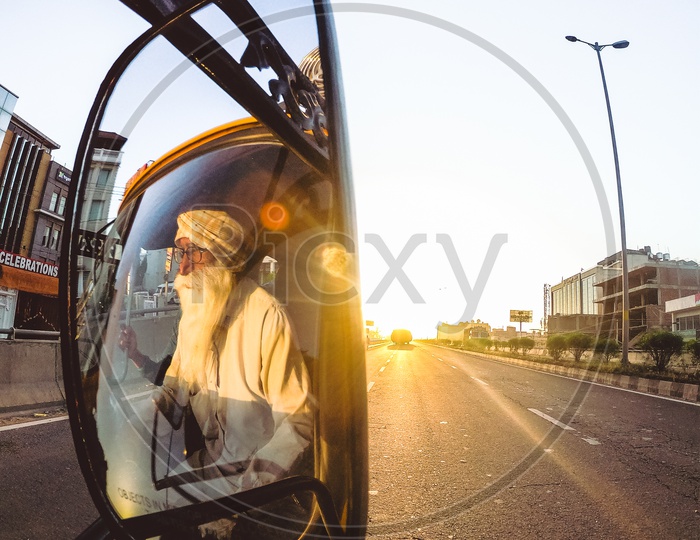 Reflection Of a Truck Driver Old Man In Rare View Side Mirror of a Truck
