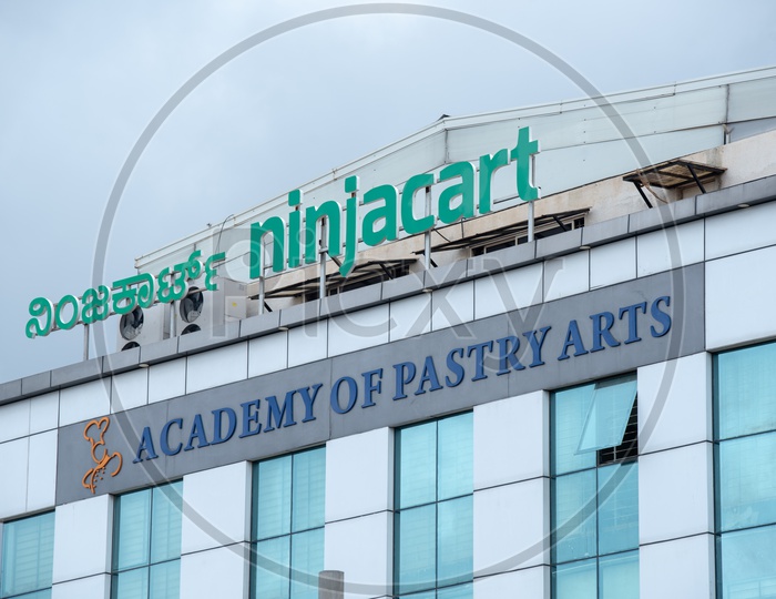 Ninjacart and Academy of Pastry Arts  Name boards on corporate office buildings