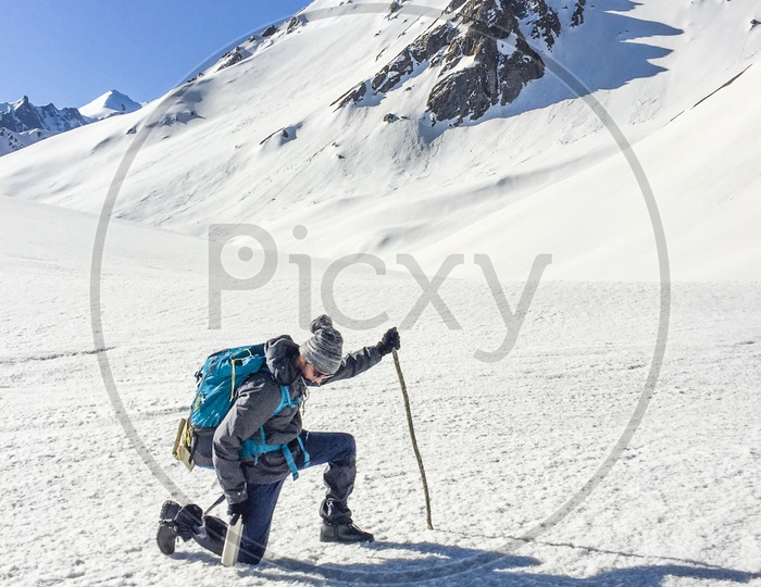 A Trekker Adventurer With Backpack On The Snow Capped Mountains In Rupin Pass