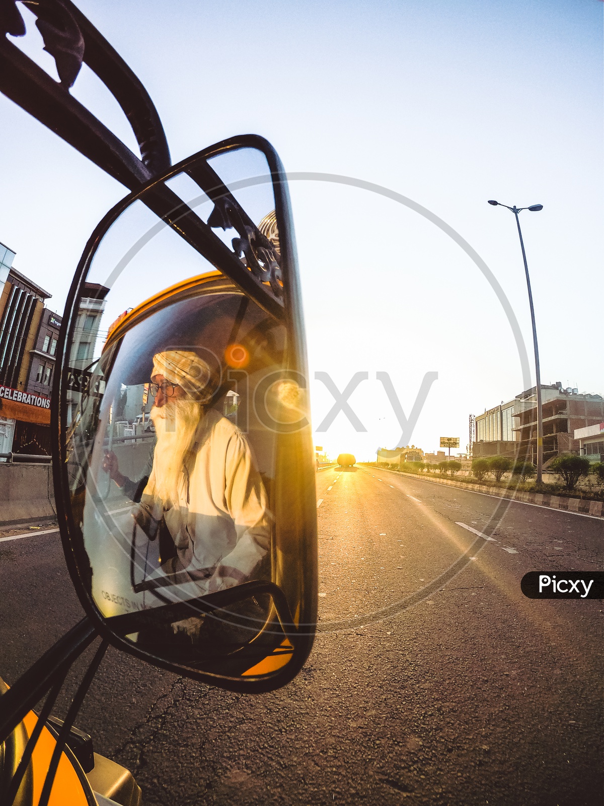 Reflection Of a Truck Driver Old Man In Rare View Side Mirror of a Truck