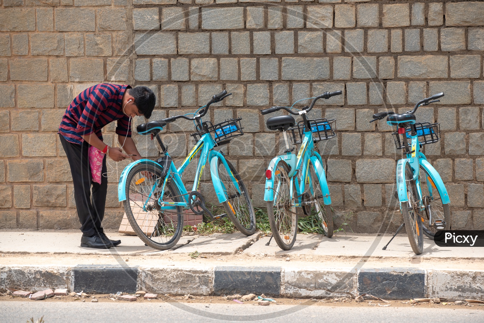 A Young man Unlocking YULU  Electric bicycle at a Hub