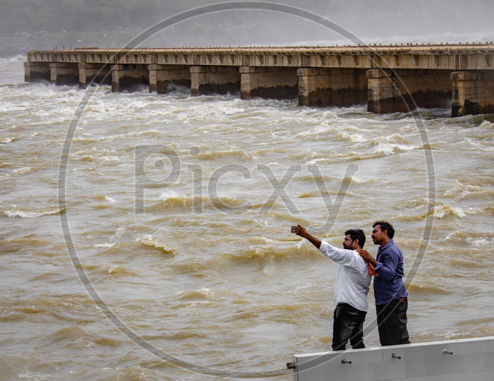 Visitors taking selfies at the water currents near nagarjuna Sagar Dam