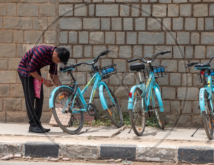 A Young man Unlocking YULU Electric Bicycle  at a Hub
