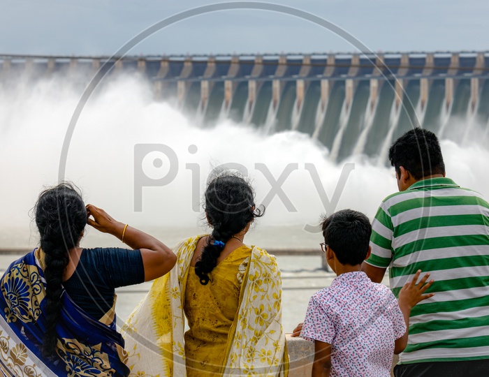 A family at Nagarjuna Sagar Dam as the gates opened water gushing