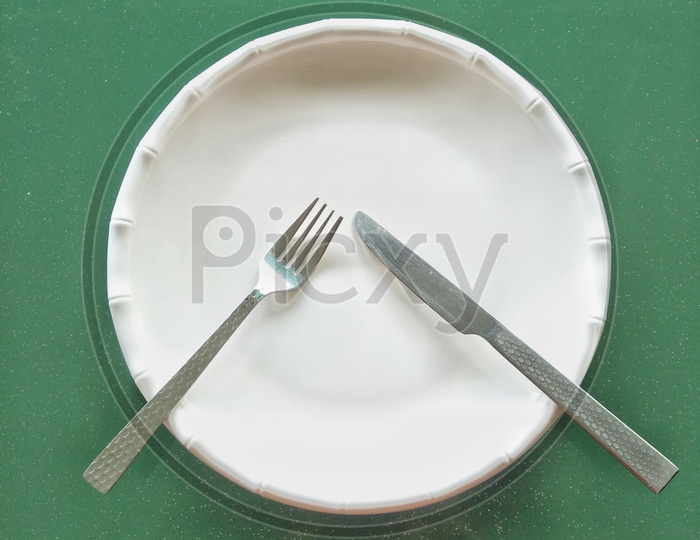 Dinner plate with knife & fork.