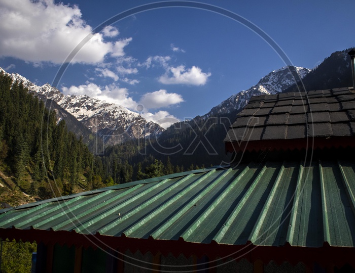 A View Of Snow Capped Mountains From The Roofs Of Village Huts In Leh