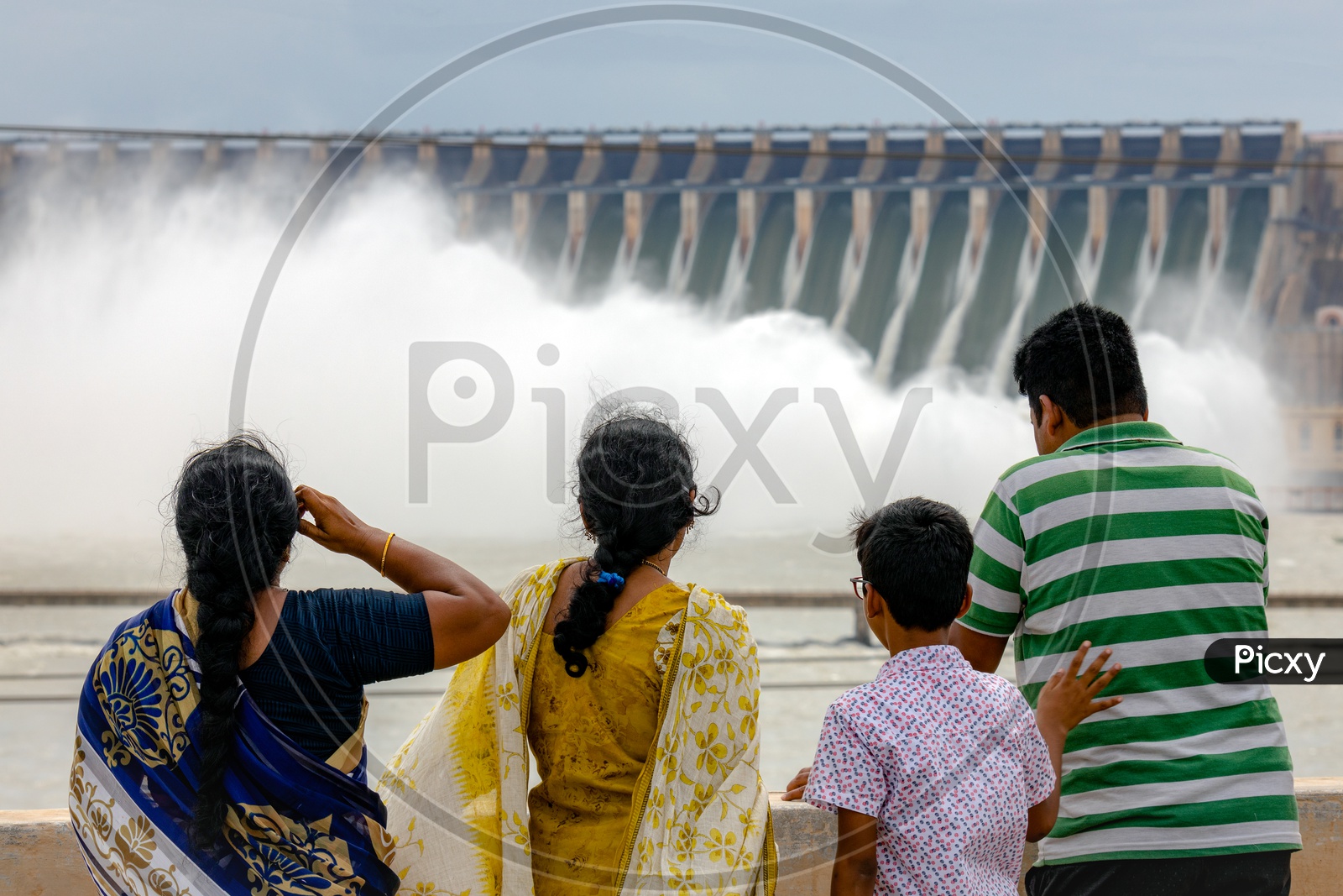 A family at Nagarjuna Sagar Dam as the gates opened water gushing