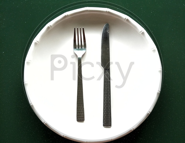Dinner plate with knife & fork.