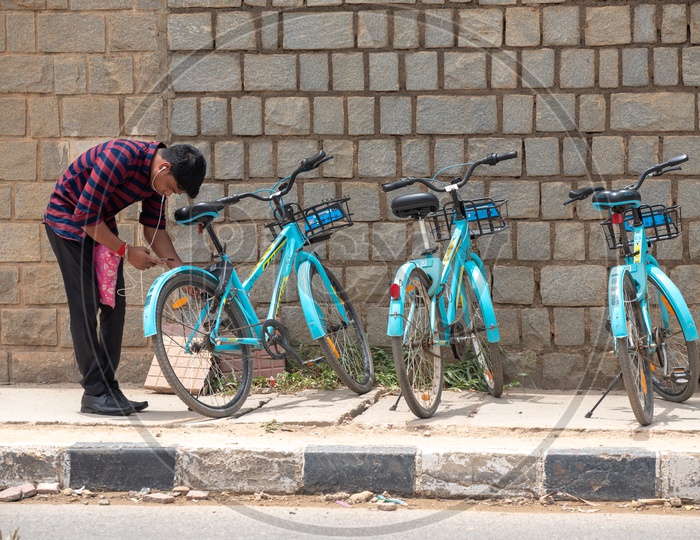 A Young man Unlocking YULU  Electric bicycle at a Hub