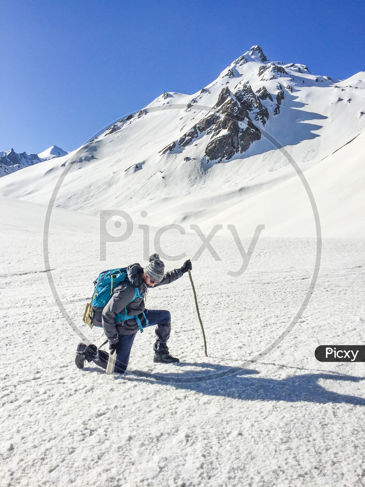 A Trekker Adventurer With Backpack On The Snow Capped Mountains In Rupin Pass
