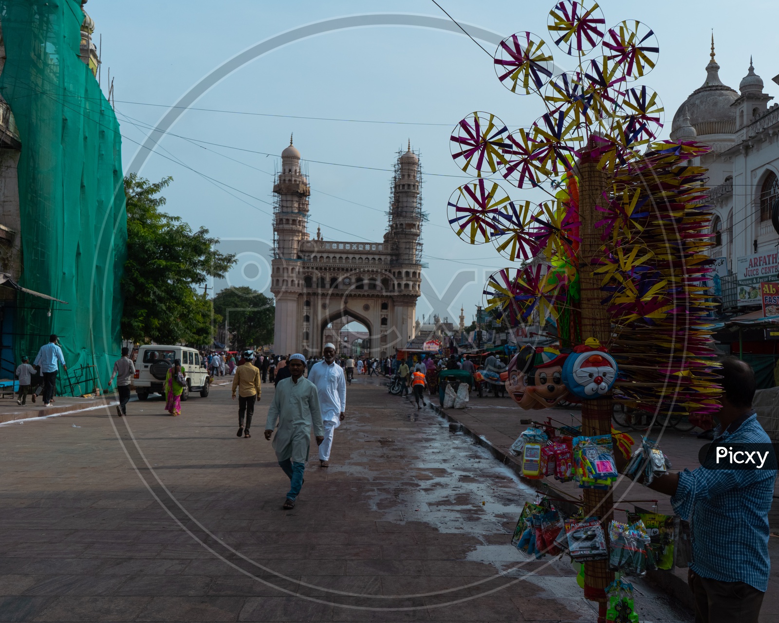 Charminar with a person selling toys in frame