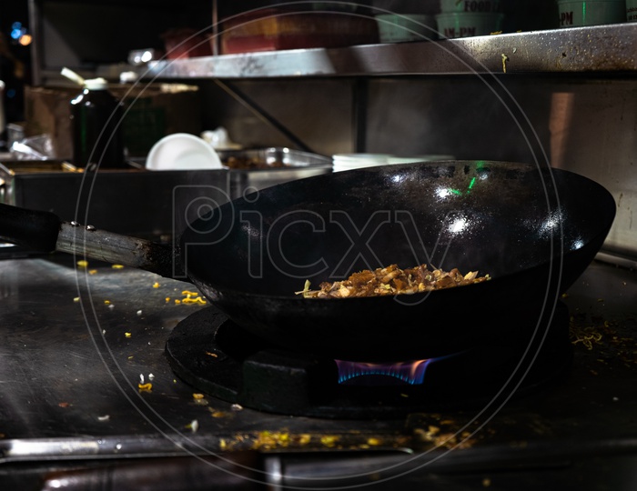 Noodles completely cooked in a wok with smoke