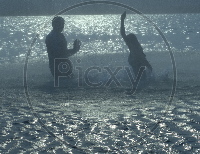 Young Indian Couple Playing in River