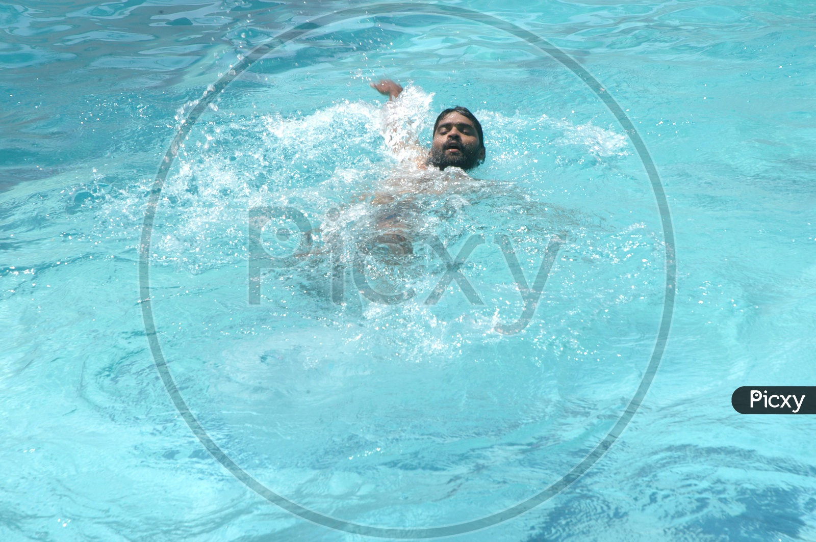 Young Man swimming in a Pool