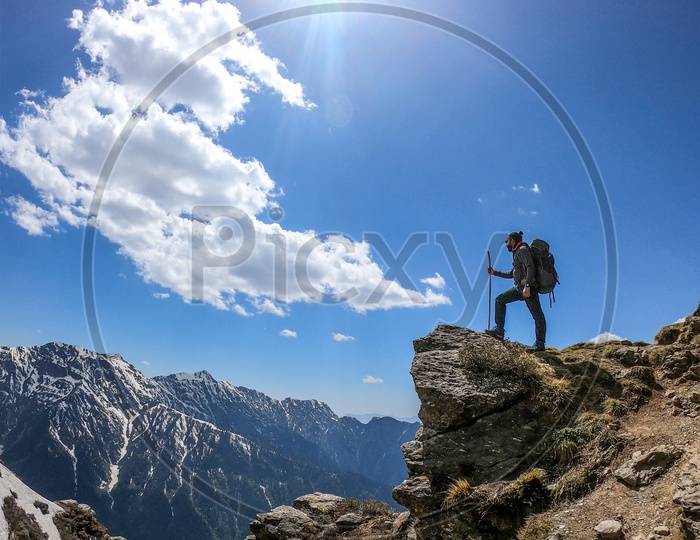 An Adventurer trekker With Backpack On mountains