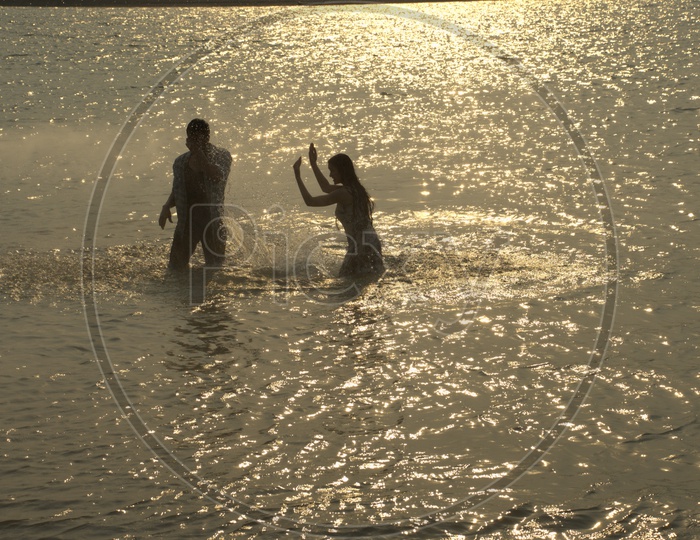 Young Indian Couple Playing in Beach