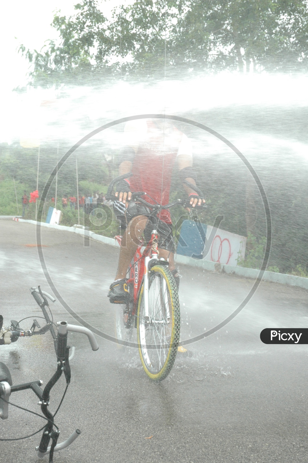 Road Bicycle Racing and Water Splashing on Face