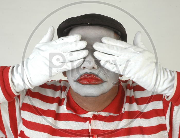 Mime Artist Closed his eyes with Hands