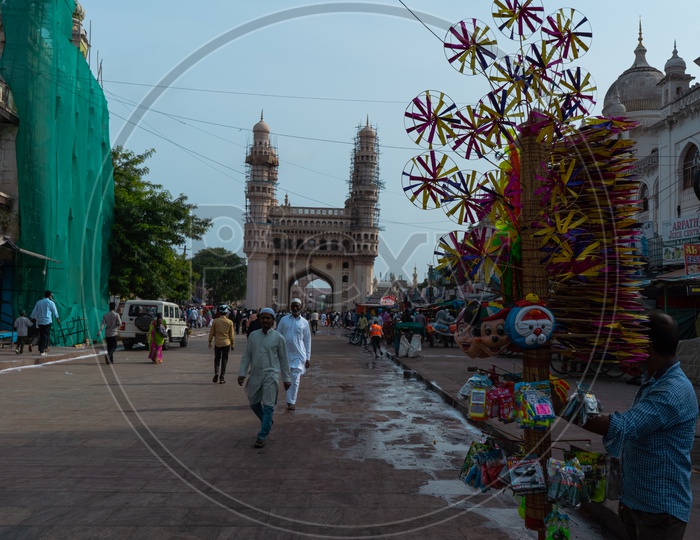 Charminar with a person selling toys in frame