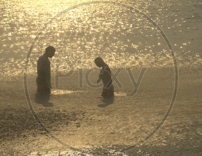 Young Indian Couple Playing in Beach