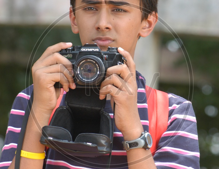 Young Boy clicking photos using Olympus Camera