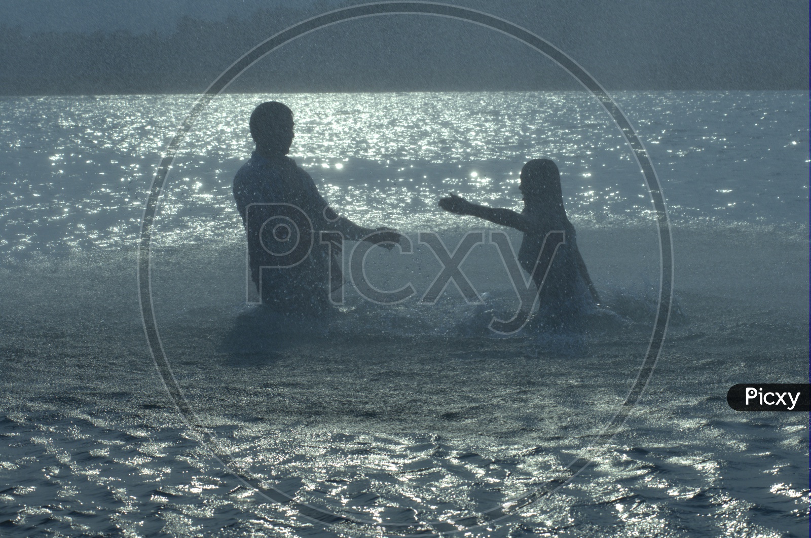 Young Indian Couple Playing in River