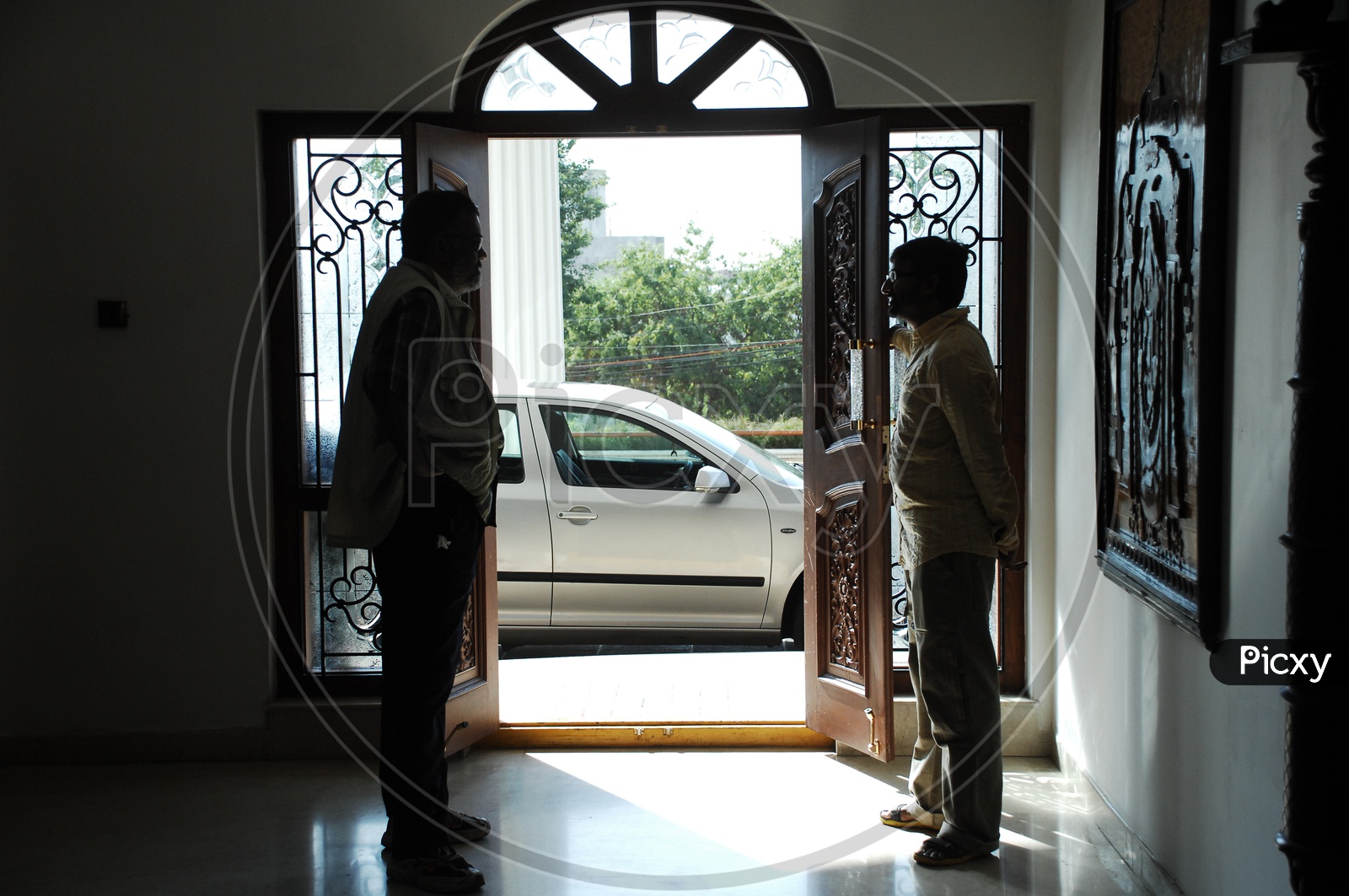 Two Man Standing At a House Entrance