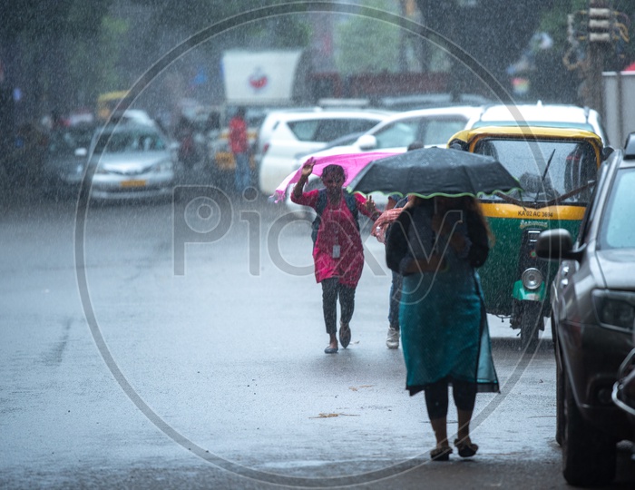 Woman walking with umbrella in heavy Rain