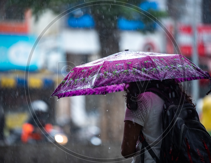 A woman,student walks in rain
