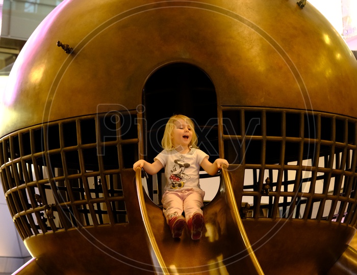 A Cute Kid Playing on Slide in Doha Airport