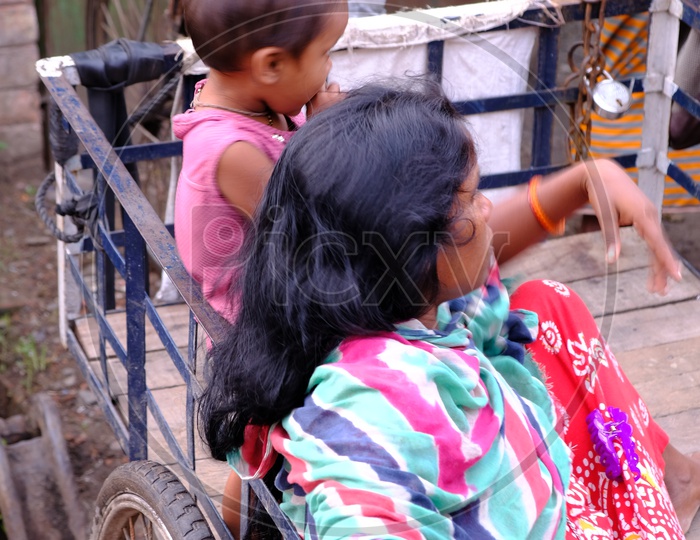 A Mother with her Child in a Rickshaw