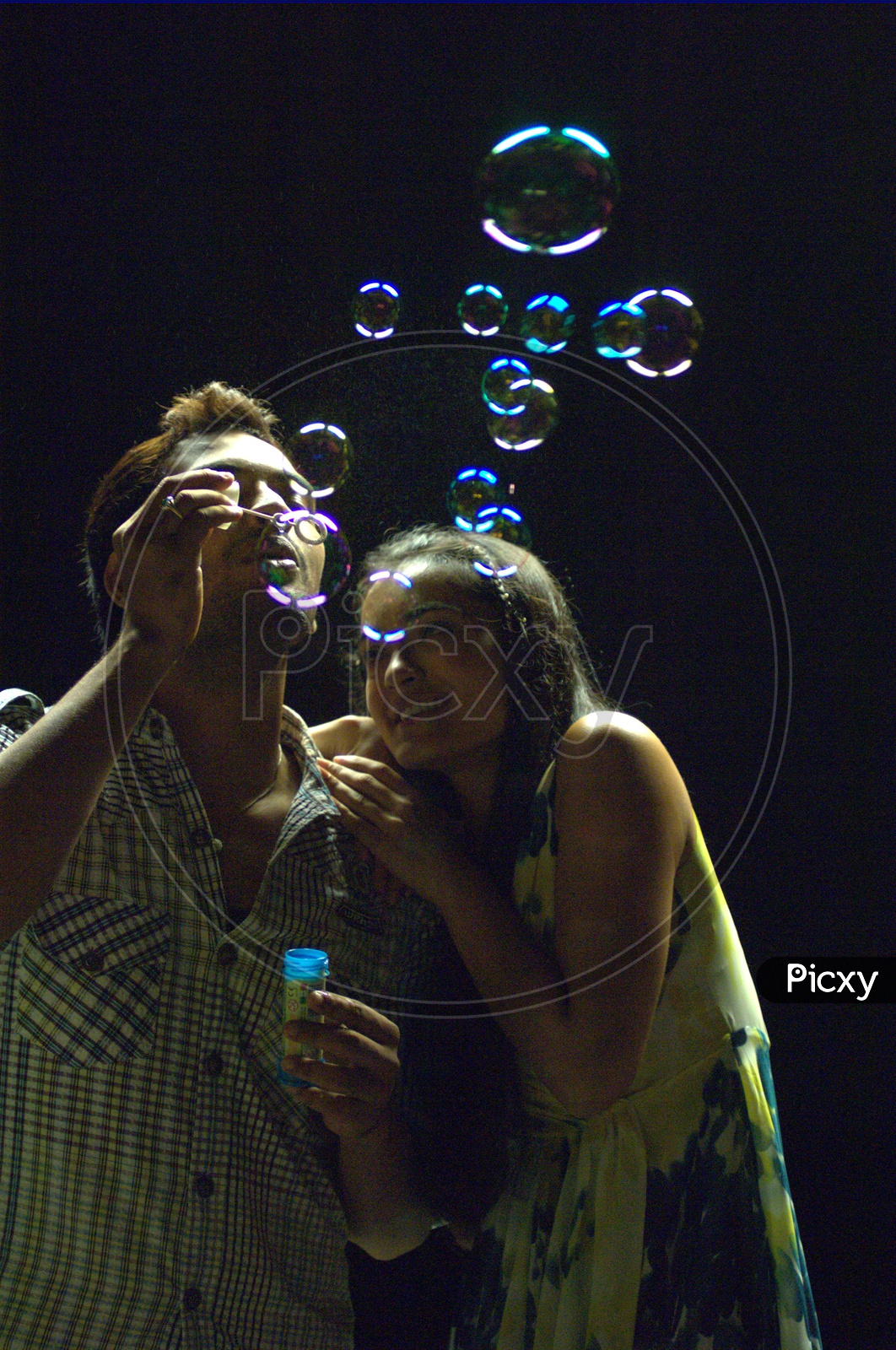 Young Indian Couple Playing with Bubbles