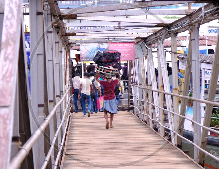 A Porter Carrying Luggage on Foot-over bridge