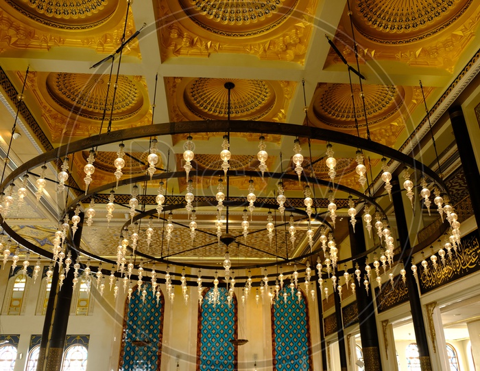 Hanging chandelier and ceiling at Katara Masjid