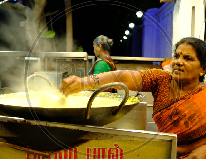 A Woman Vendor at a Hot Badam Milk Almond Milk Vendor Stall