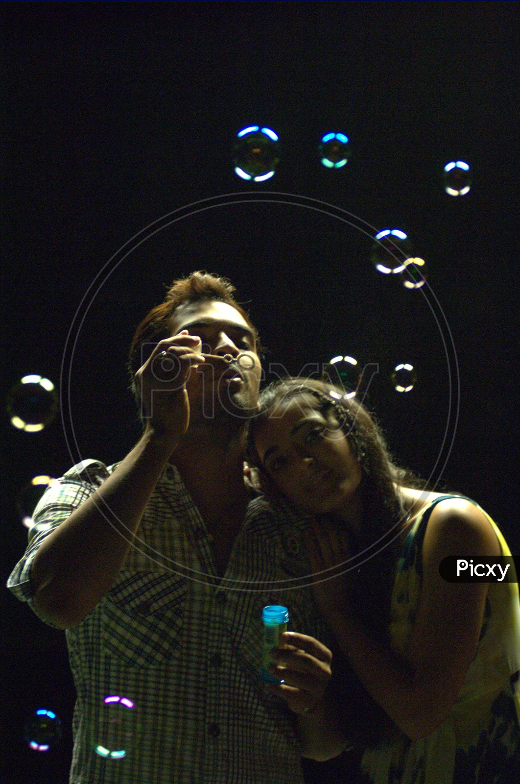 Young Indian Couple Playing with Bubbles