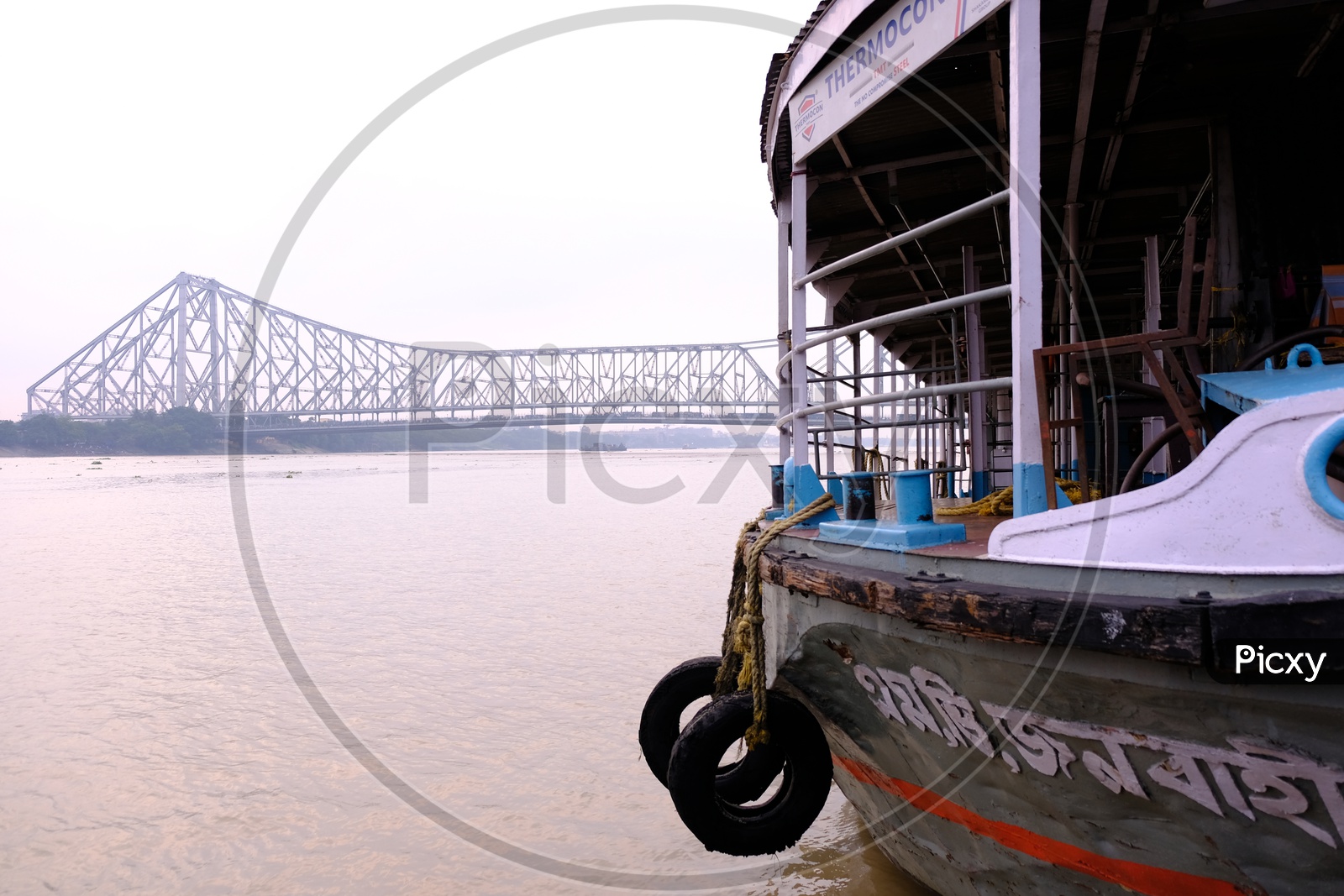 A Tourist Boat in Hooghly River with Howrah Bridge